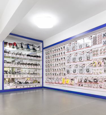 Wide selection of motorcycle lights and spare parts displayed in a wholesale  showroom shop.