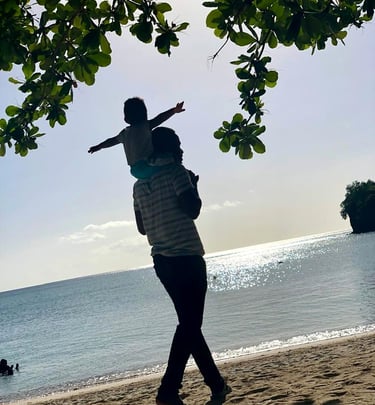 Father and son enjoying a walk at Grand Anse Beach