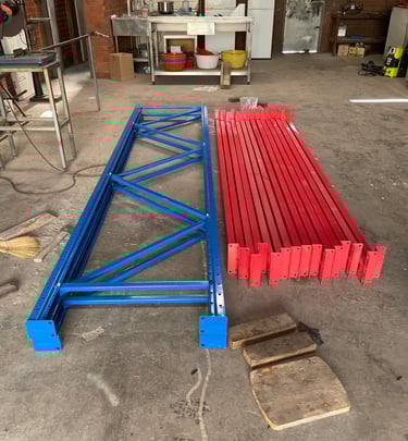Assembled steel pallet racking uprights and horizontal beams positioned side by side.