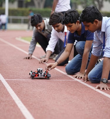 Excited students showcasing their drone flying skills outdoors