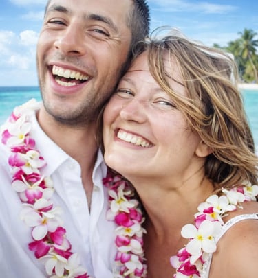 a man and woman standing in front of a beach in Carribean