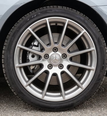 Close-up of a shiny black luxury sedan after a meticulous mobile detailing session under natural sunlight