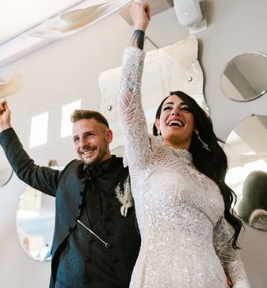 a man and woman standing in front of a mirror