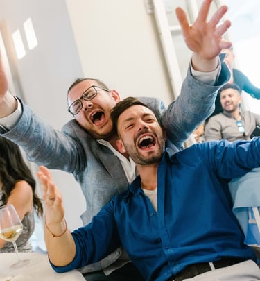 a man and woman sitting at a table with wine glasses