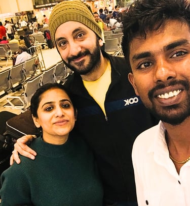 Couple greeted by a friendly driver at Colombo Airport for a private transfer.