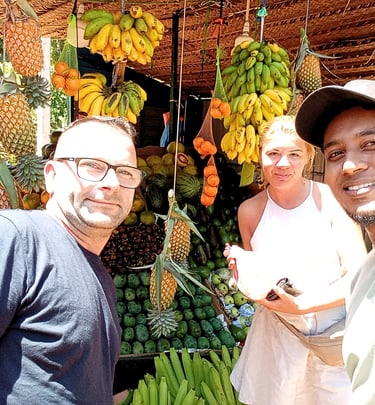 Couple exploring a Sri Lankan vegetable market with their tour driver during a private day tour.
