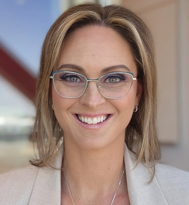 a woman in glasses and a white jacket