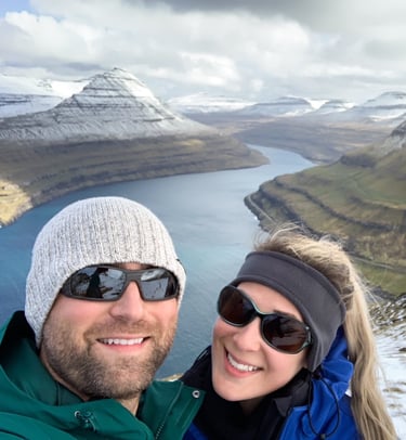 A smiling couple with a mountain vista behind them