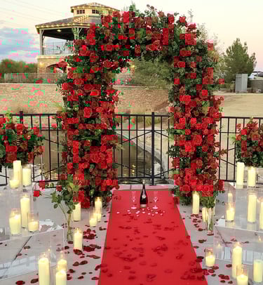 romantic red rose wedding ceremony arch red carpet surprise proposal with candles and rose petals