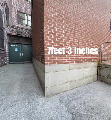 A blank exterior wall in a school play area.