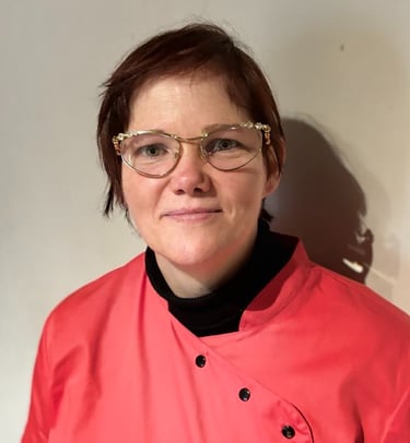 a nurse in a pink jacket and glasses