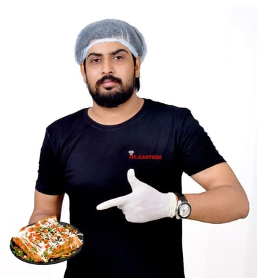 a man in a surgical mask and gloves holding a pizza