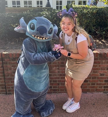 Ameliah Knopp pictured with Stitch at EPCOT®.