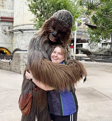 Sarah Brewer pictured with Chewbacca inside Galaxy's Edge inside Disney's Hollywood Studios® Park.