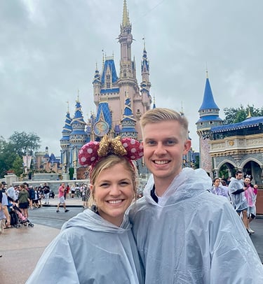 Kasey Kalk pictured with her husband in front of Cinderella Castle at Disney's Magic Kingdom®.