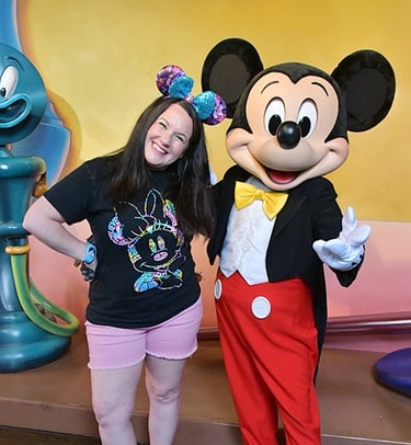 Kristen Breedlove pictured with Mickey Mouse at Disneyland® Park.