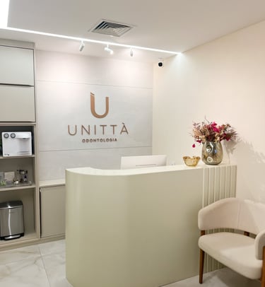 a reception area with a reception table, flowers and chairs