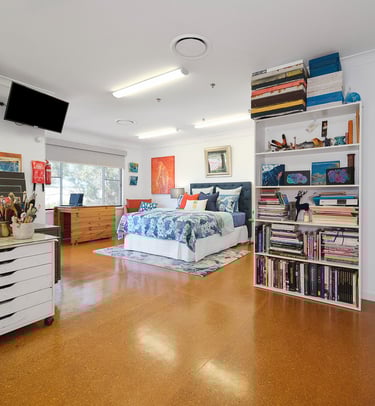 Artist Studio at Marche Home Stay with a cosy queen bed, art workspace, colourful decor, and private ensuite access.