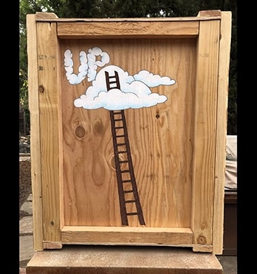 Shipping crate for Talbotics sculpture with image of ladder into the clouds drawn on it.