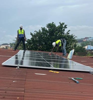 Technician installing solar panels on a rooftop