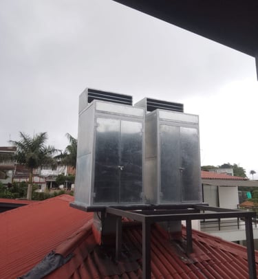 two large metal containers sitting on top of a roof