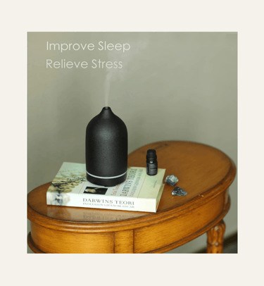 picture of a matte black stone essential oil diffuser on a vintage table