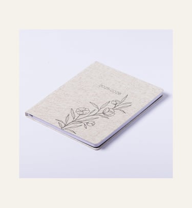 picture of a linen colored daily planner closed with sketch of flowers and 2025-2026 on it