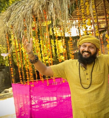 a man in a yellow turban and a pink scarf