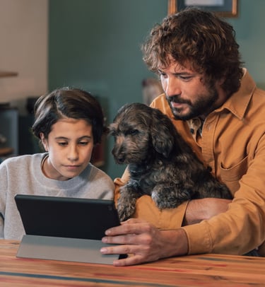 a man and a dog are sitting at a table