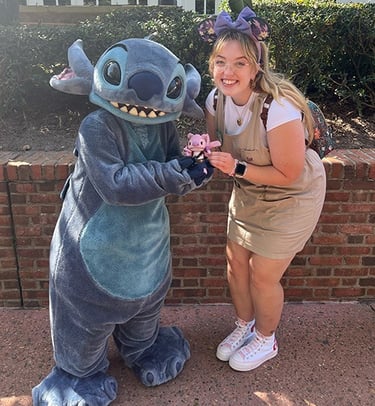 Ameliah Knopp pictured with Stitch at EPCOT®.