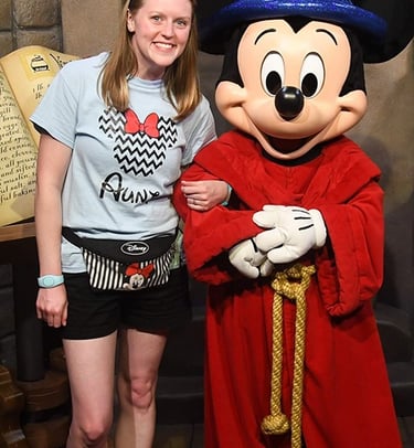 Aimee Cochrane pictured with Sorcerer Mickey at Disney's Hollywood Studios® inside Walt Disney World®.