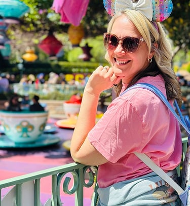 Emily Brisson pictured in front of the Mad Tea Party teacups at Disneyland® Park.