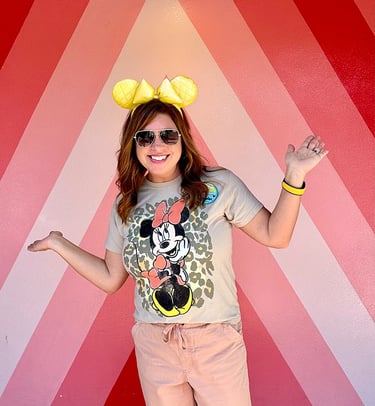 Karen Amundson in front of the "Future World" photo wall at EPCOT®.