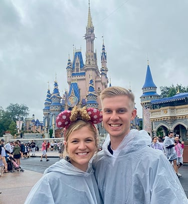 Kasey Kalk pictured with her husband in front of Cinderella Castle at Disney's Magic Kingdom®.