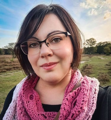 Doula Valentina - me- a woman in glasses and a pink scarf around her neck