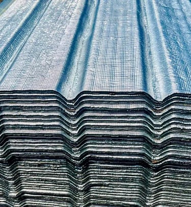a stack of corrugated steel sheets with a blue sky background