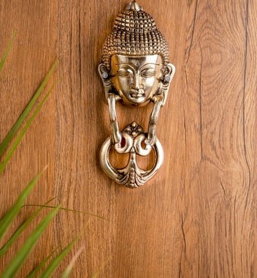 a door knocker with a buddha statue on it
