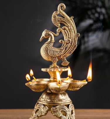 a golden colored peacock sitting on a brass lap