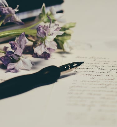 Image of purple flowers on paper. Photo credit: Unsplash and Debby Hudson