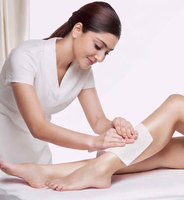 a woman is getting her leg waxed by a wax strip