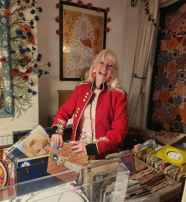 DJ Charlotte Hypno Bird playing records at a 60th birthday party wearing 60s vintage dress 