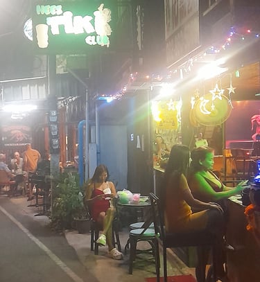 Thai women sat outside Nees Tiki Club on Petchkasem Road in Hua Hin