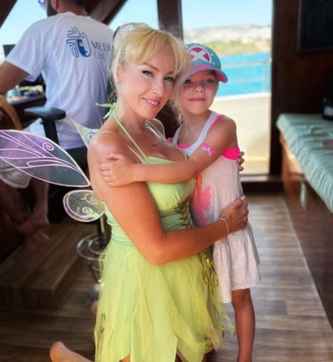 Fairy performer with a child guest on a family boat tour in Cyprus
