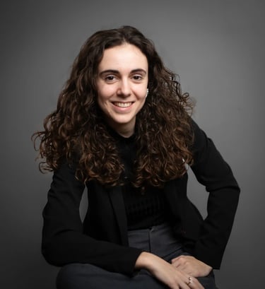 a woman with curly hair and a black jacket