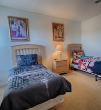 a bedroom with two twin beds and a lamp