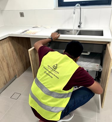 Civil Engineer inspecting under the basin for water leak