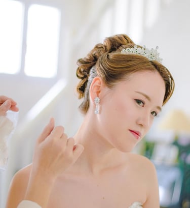 a woman in a wedding dress is wearing a tiablet