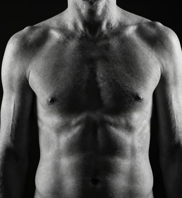An abstract fine-art study of a human torso in monochrome. High contrast lighting accentuating the muscular lines and skin texture. The background is pitch black, creating a sense of depth and mystery. North American / US artistic style.