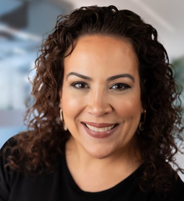 a woman with curly hair and a black shirt