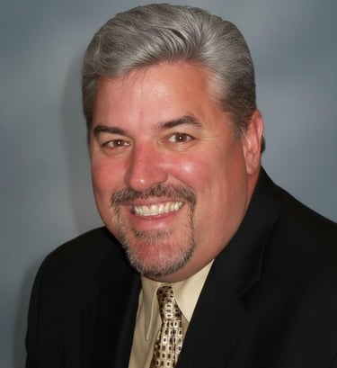 a man in a suit and tie smiling